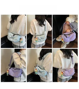 Detail view of stylish nylon dumpling bags in blue and purple with adjustable straps