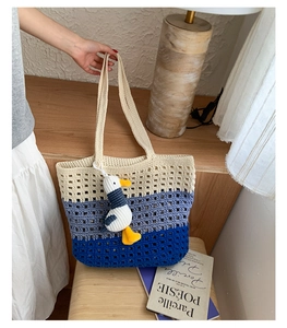 Detail of hollow woven tote bag with three-tone gradient and cute plush charm