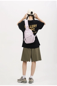 Close-up of a light purple nylon crossbody chest bag with adjustable wide shoulder strap