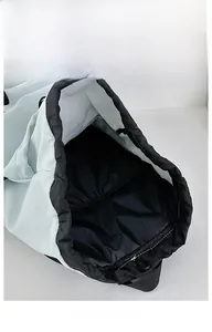 Interior view of water-resistant drawstring backpack with laptop sleeve and blue lining