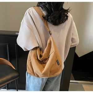 Sac hobo en toile marron montrant sa grande capacité et sa large bandoulière réglable