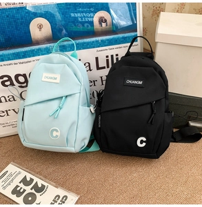 Detail view of water-resistant nylon chest bags with brand tags in blue and black colors