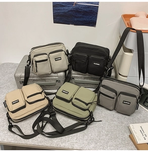 Detail of multi-pocket nylon crossbody bags in black, grey, green, khaki, and beige