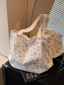 Floral lace tote bag with blue and pink flowers on cream fabric and shoulder straps