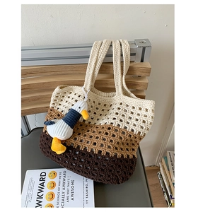 Detailed knit tote bag with tricolor patchwork, hollow-out mesh design, and duck charm