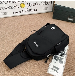 Detail of black crossbody chest bag with adjustable strap and Chuangmi logo patch