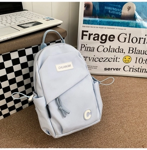 Close-up of light blue water-resistant nylon chest bag with minimalist brand label