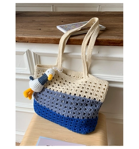 Detail of three-color crochet tote bag with hollow grid texture and cute plush charm
