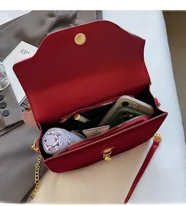 Interior view of red bridal handbag showing large capacity for phone and essentials