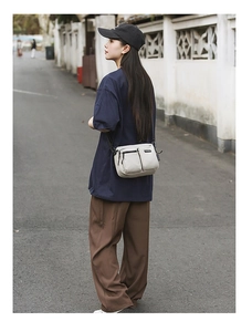 Beige casual crossbody bag styled with street wear for an urban outdoor look