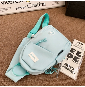 Light blue minimalist chest bag showing the large main pocket and front flap velcro pocket