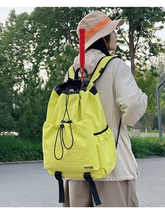 Detail of neon yellow drawstring sports bag showing large capacity for badminton rackets
