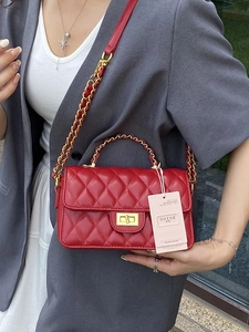 Elegant red quilted leather crossbody bag with gold chain strap and turn-lock closure