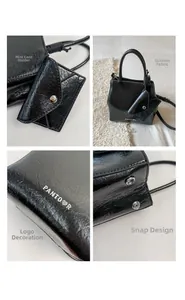Detail view of black matte leather bag with metal PANYOOR logo and mini card holder