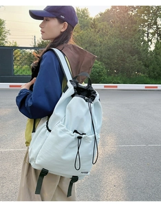 Detail view of light blue water-resistant drawstring backpack for outdoor activities