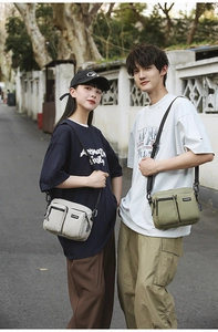 Detail of dual front pockets and durable nylon fabric on a casual crossbody bag