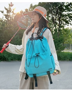 Waterproof drawstring backpack in cyan blue featuring a side pocket and front buckle flap