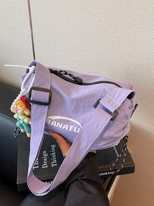Fashionable light purple nylon dumpling bag with adjustable strap and cute charm