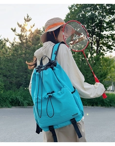 Outdoor shot of bright blue lightweight waterproof drawstring backpack for hiking