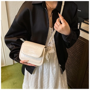 Sac bandoulière crème chic avec texture plissée et breloque en perles et dentelle