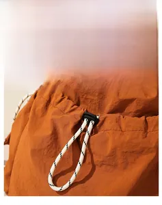 Detail of lightweight backpack fabric with woven drawstring and plastic cord lock