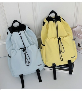 Lightweight water-resistant drawstring backpacks in blue and yellow colors with TUTTIE logo
