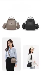 Detail of elegant shell crossbody bag with adjustable wide strap and textured finish