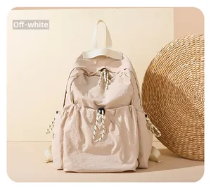 Close-up of beige nylon backpack with functional drawstring pockets and soft texture