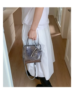 Silver metallic mini handbag featuring pleated texture and detachable triangle coin pouch