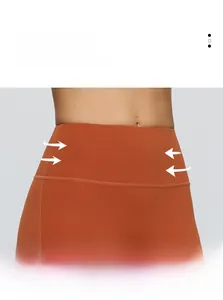 Detail of high-waist burnt orange yoga pants showing elastic compression and waist stitching