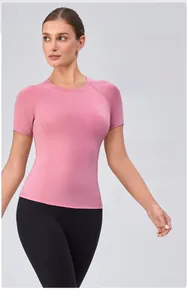Close-up of pink sports top featuring comfortable crew neck and raglan sleeve design