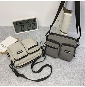 Detailed view of durable nylon canvas crossbody bags with multiple zipper pockets