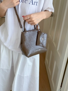 Brown oil-wax leather trapezoid handbag with dual handles and crossbody strap