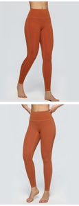 Macro detail of high-waisted orange yoga pants with elastic seams and textured fabric