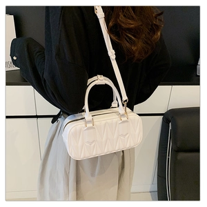Detailed back view of a white quilted leather shoulder bag with gold zipper and hardware
