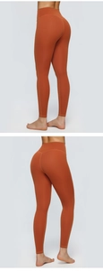 Close-up of vibrant orange high-waist yoga pants with seamless moisture-wicking fabric