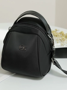 Modern black nylon shell bag featuring multi-layer zippers and a wide shoulder strap