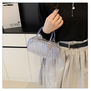 Detail of purple transparent PVC mini bag with geometric wave texture and gold hardware