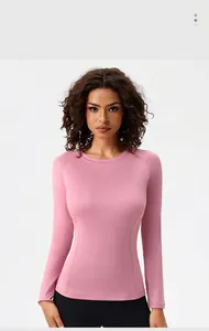 Detail of pink long sleeve yoga top featuring ergonomic curved stitching and dry-fit fabric
