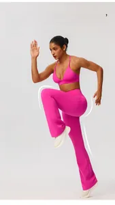 Close-up of rose pink high-stretch yoga top and flared leggings set on active model