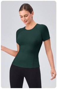 Detail of dark green quick-dry yoga t-shirt showing raglan sleeves and fabric texture