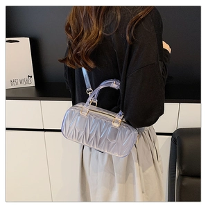 Detail showing transparent purple PVC crossbody bag with quilted texture and silver zipper