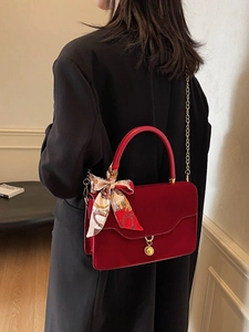 Elegant red vintage bridal handbag with gold chain strap and decorative silk scarf