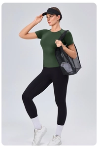 Detail of dark green tight yoga top showing slim fit cut and elastic athletic fabric