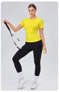Detail of ergonomic seams on a tight-fitting yellow yoga t-shirt with tennis racket