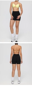 Detail of cross-back halter neck sports bra and high-waist fitness shorts for workout