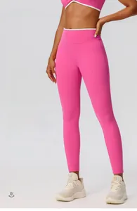 Detail of high-waist rose pink yoga leggings showing slimming fit and smooth fabric texture