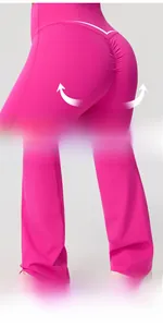 Detail of high waist yoga flare pants featuring ruched booty lifting design in pink