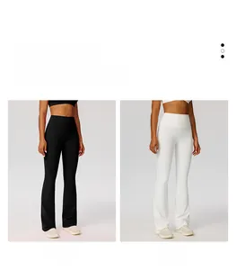 Detail of high-waist flared yoga pants in black and white with wide tummy control waistband