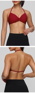 Detail view of burgundy halter sports bra with center ruching and black high waist leggings